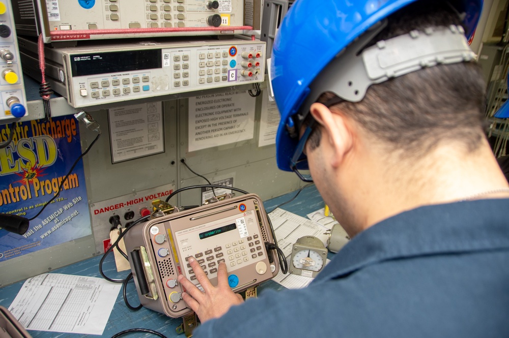 USS Ronald Reagan (CVN 76) Sailors calibrate a direct current ammeter