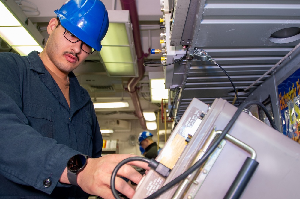 USS Ronald Reagan (CVN 76) Sailors calibrate a direct current ammeter