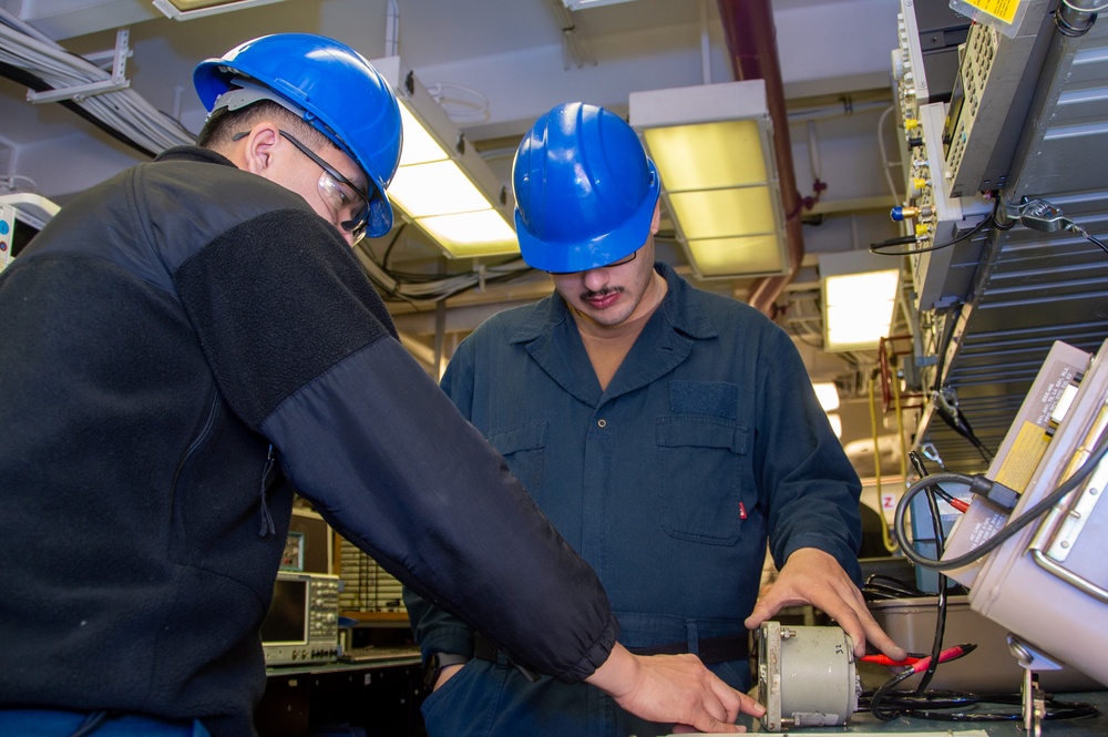 USS Ronald Reagan (CVN 76) Sailors calibrate a direct current ammeter