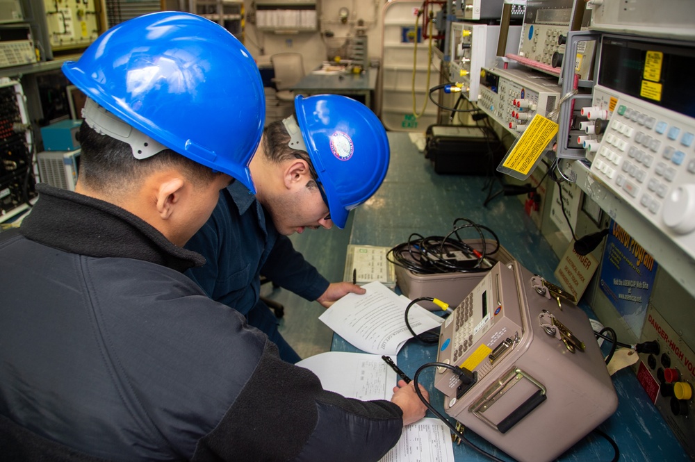 USS Ronald Reagan (CVN 76) Sailors calibrate a direct current ammeter