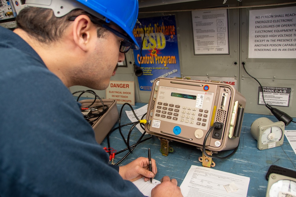 USS Ronald Reagan (CVN 76) Sailors calibrate a direct current ammeter