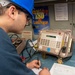 USS Ronald Reagan (CVN 76) Sailors calibrate a direct current ammeter