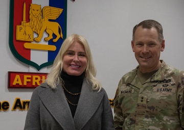 Maj. Gen. Todd Wasmund presents Patricia Tasad with a SETAF-AF coin
