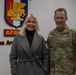 Maj. Gen. Todd Wasmund presents Patricia Tasad with a SETAF-AF coin