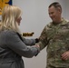 Commanding General Todd Wasmund presents Patricia Tasad with a SETAF-AF coin