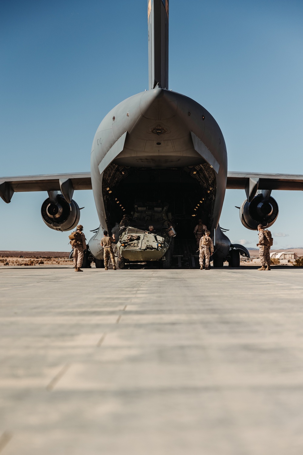 Marines with 3rd LAR load tactical vehicles onto Air Force C-17 Globemaster III cargo aircraft