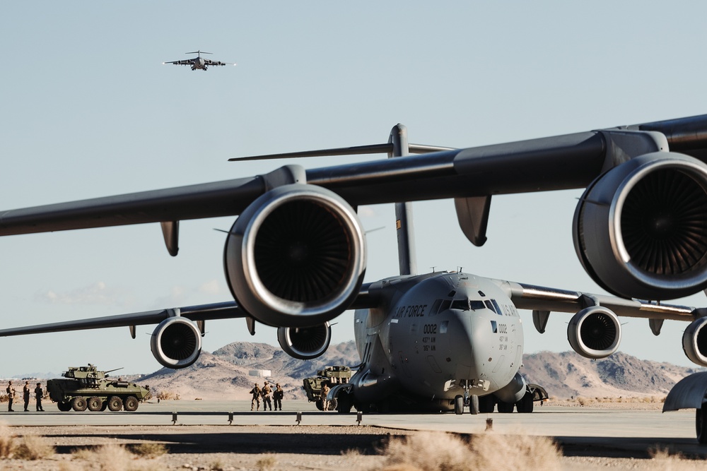 Marines with 3rd LAR load tactical vehicles onto Air Force C-17 Globemaster III cargo aircraft