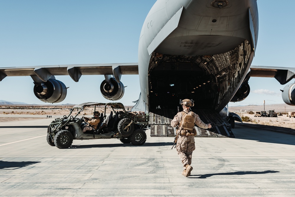 Marines with 3rd LAR load tactical vehicles onto Air Force C-17 Globemaster III cargo aircraft