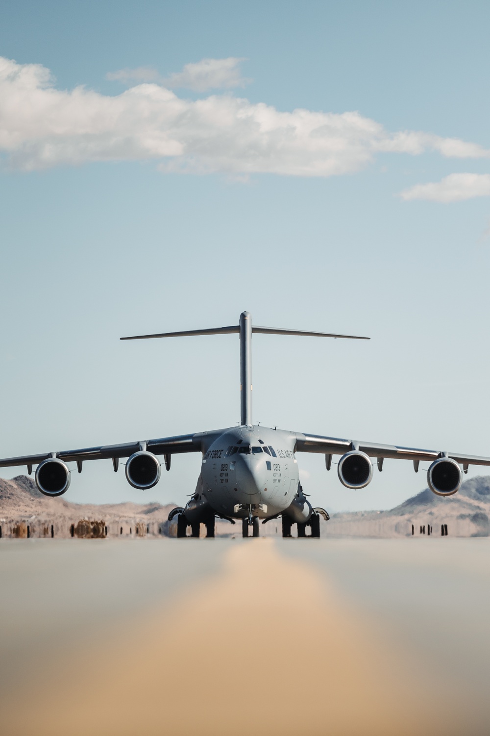 Marines with 3rd LAR load tactical vehicles onto Air Force C-17 Globemaster III cargo aircraft