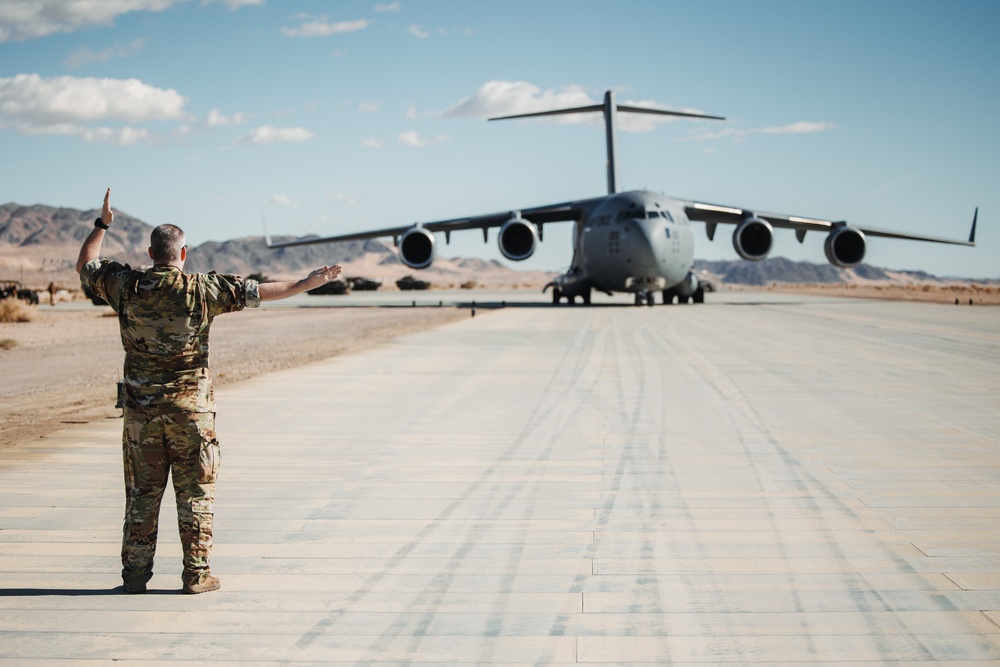 Marines with 3rd LAR load tactical vehicles onto Air Force C-17 Globemaster III cargo aircraft