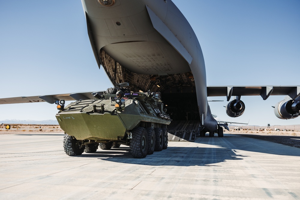 Marines with 3rd LAR load tactical vehicles onto Air Force C-17 Globemaster III cargo aircraft