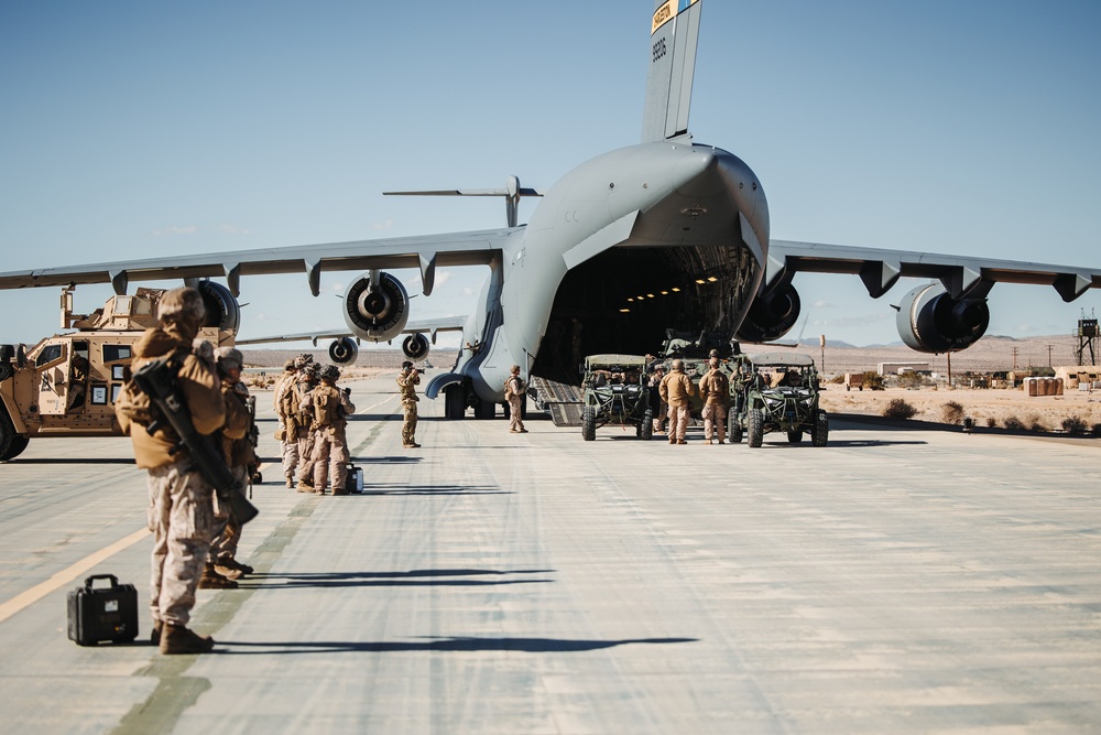 Marines with 3rd LAR load tactical vehicles onto Air Force C-17 Globemaster III cargo aircraft