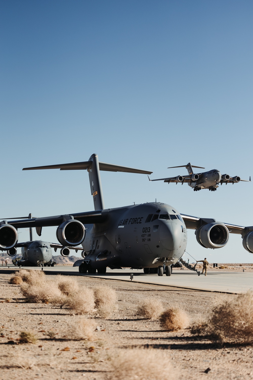 Marines with 3rd LAR load tactical vehicles onto Air Force C-17 Globemaster III cargo aircraft