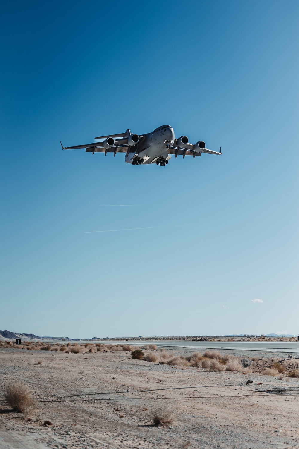 Marines with 3rd LAR load tactical vehicles onto Air Force C-17 Globemaster III cargo aircraft