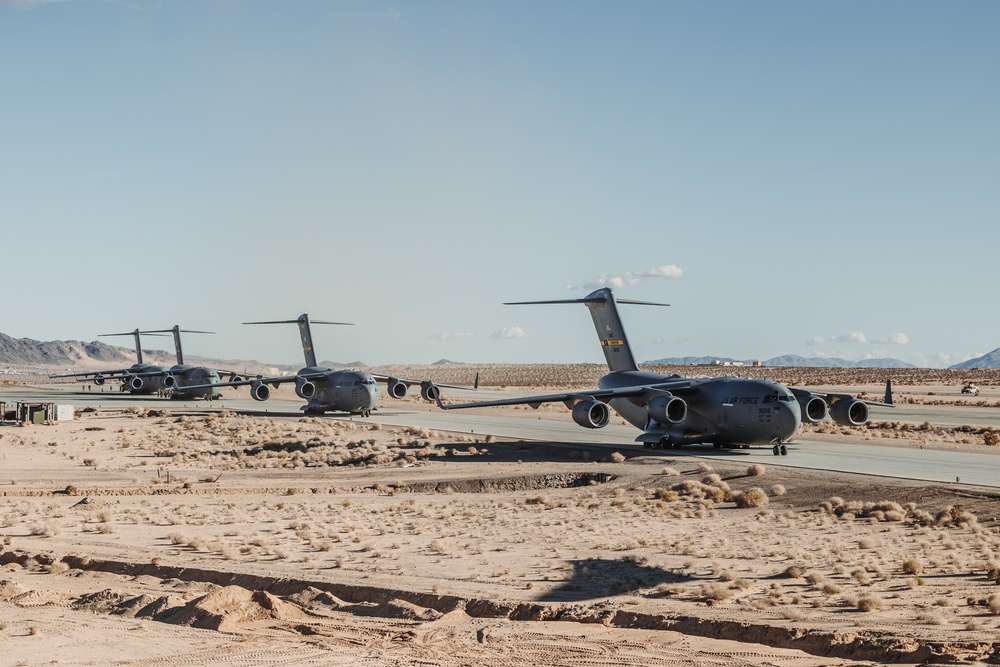 Marines with 3rd LAR load tactical vehicles onto Air Force C-17 Globemaster III cargo aircraft