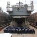 The crew of the USS Benfold (DDG 65) pose for a group photo in a dry dock onboard Commander, Fleet Activities Yokosuka