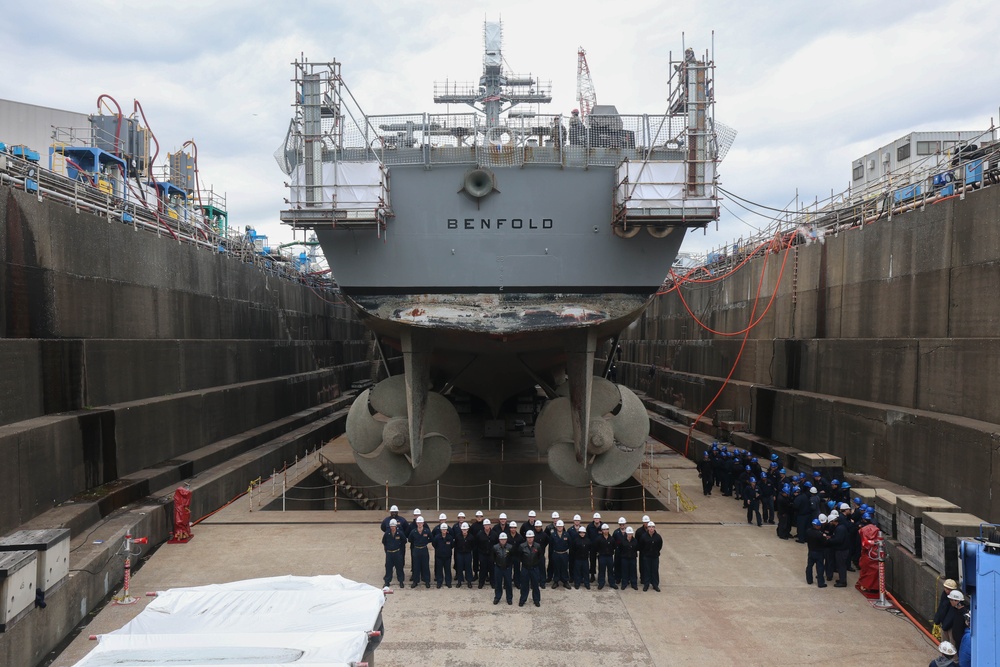 The wardroom of the USS Benfold (DDG 65) pose for a group photo in a dry dock onboard Commander, Fleet Activities Yokosuka