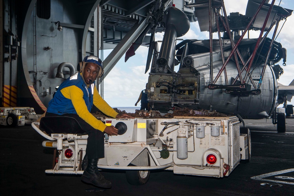 USS Carl Vinson (CVN 70) Sailor taxies an MH-60S Sea Hawk