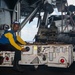 USS Carl Vinson (CVN 70) Sailor taxies an MH-60S Sea Hawk