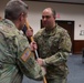 38th Infantry Division Headquarters Support Company commander receives company guidon during change of command ceremony