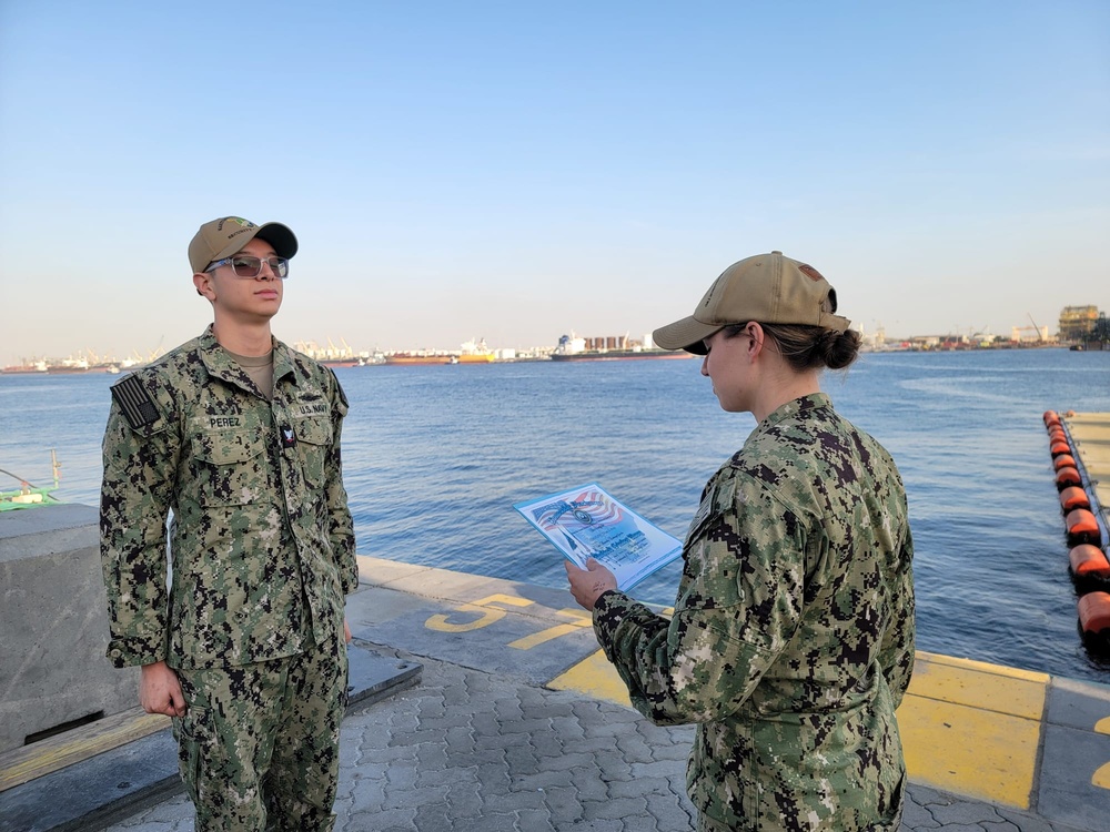 Gunner’s Mate 3rd Class Adriano Perez assigned to Maritime Expeditionary Security Squadron (MSRON) 2 Alpha company reenlists on the pier during his United Arab Emirates deployment.