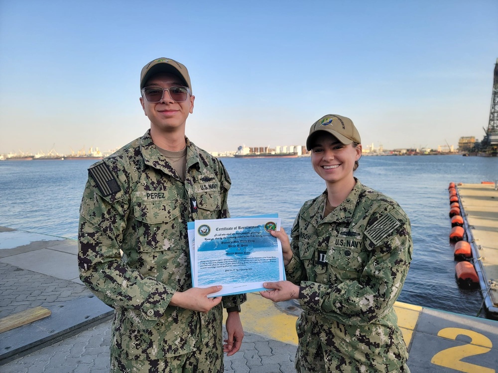 Gunner’s Mate 3rd Class Adriano Perez assigned to Maritime Expeditionary Security Squadron (MSRON) 2 Alpha company reenlists on the pier during his United Arab Emirates deployment.