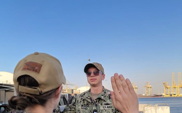 Gunner’s Mate 3rd Class Adriano Perez assigned to Maritime Expeditionary Security Squadron (MSRON) 2 Alpha company reenlists on the pier during his United Arab Emirates deployment.