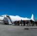 Members of the USSTRATCOM Component Commanders Conference wait beside an E-6B Mercury to view a flyover by an Air Force B52, Feb. 5, 2024.