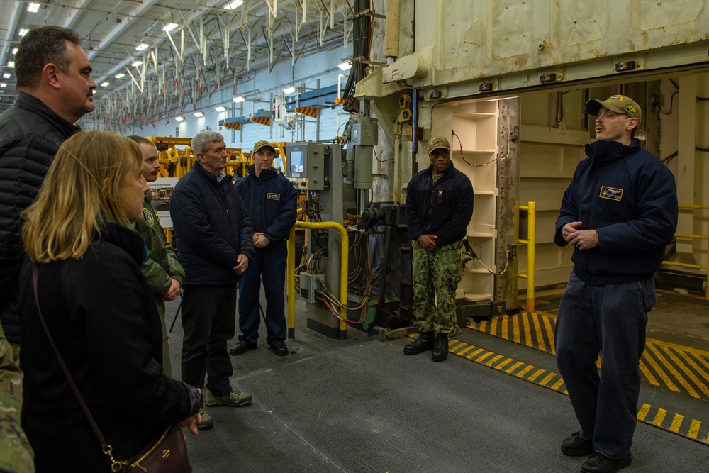 Aviation Ordnanceman 2nd Class Cody Lindenbusch gave a tour of the elevator systems aboard USS Gerald R. Ford (CVN 74) to members of the USSTRATCOM Component Commanders Conference, Feb. 5, 2024.