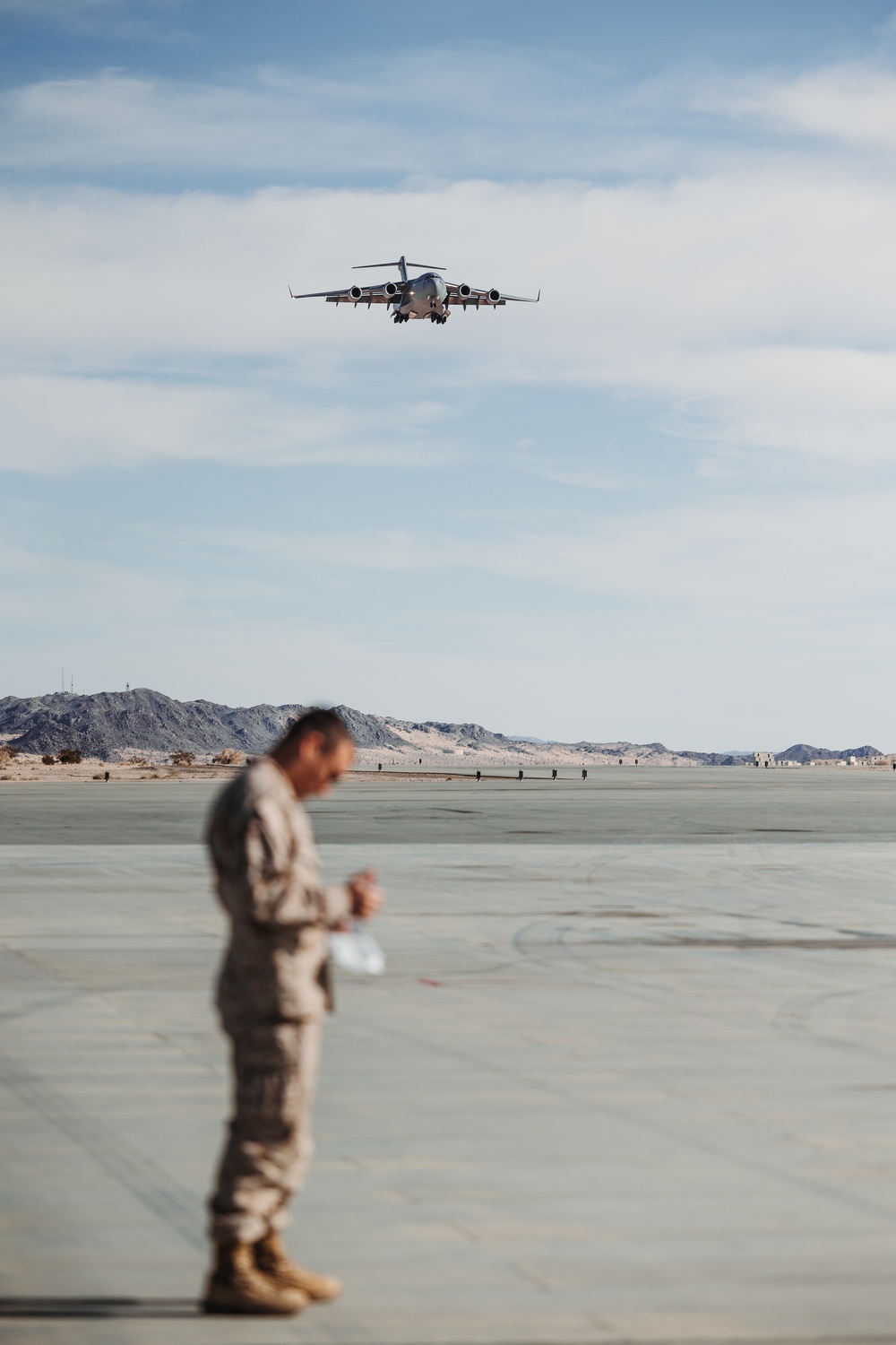Marines with 3rd LAR unload tactical vehicles off of Air Force C-17 Globemaster III cargo aircraft