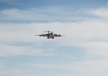Marines with 3rd LAR unload tactical vehicles off of Air Force C-17 Globemaster III cargo aircraft
