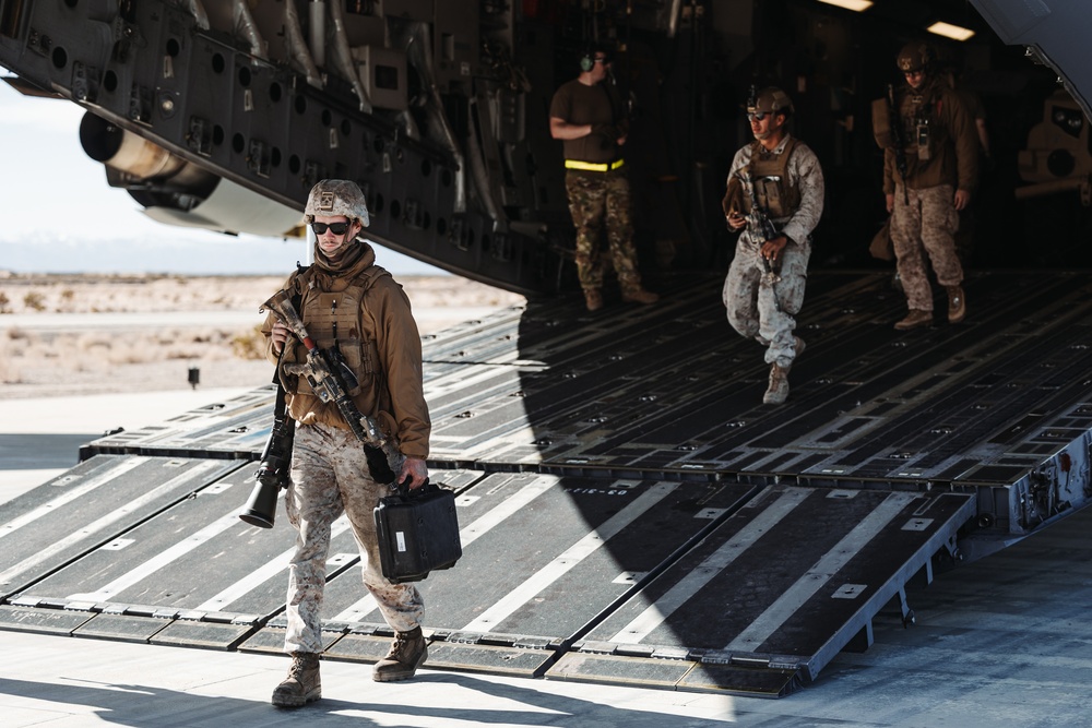 Marines with 3rd LAR unload tactical vehicles off of Air Force C-17 Globemaster III cargo aircraft