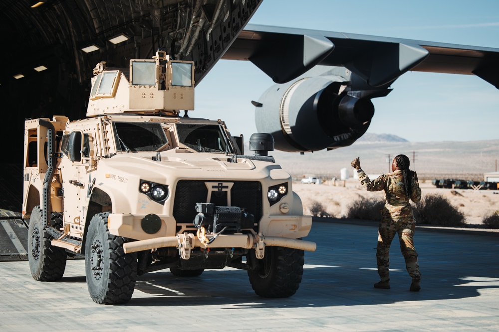 Marines with 3rd LAR unload tactical vehicles off of Air Force C-17 Globemaster III cargo aircraft
