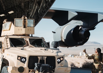 Marines with 3rd LAR unload tactical vehicles off of Air Force C-17 Globemaster III cargo aircraft