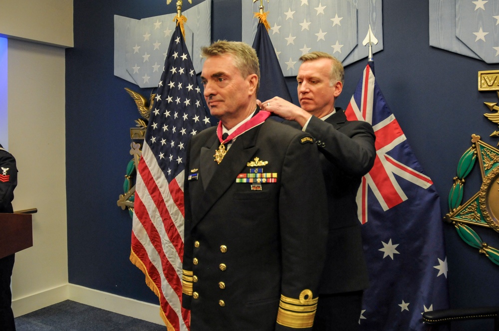 The Under Secretary of the Navy Erik Raven presents Royal Australian Navy Vice Adm. Jonathan Mead with the Legion of Merit