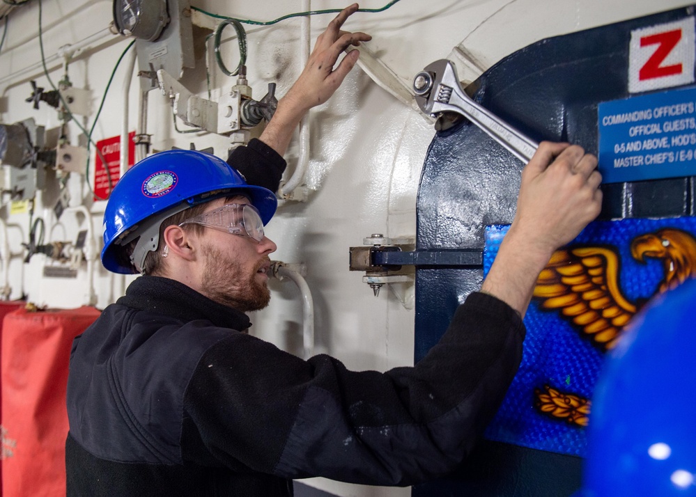 USS Ronald Reagan (CVN 76) Sailors troubleshoot a quick-acting water tight door