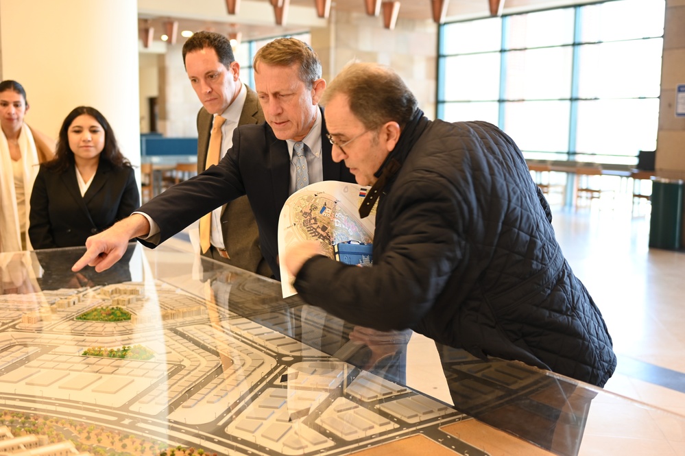 USAID ME SDAA Andrew Plitt, AUC President Ahmad Dallal, and USAID Egypt Mission Director Sean Jones examine an architectural model of AUC campus, February 5, 2024.
