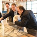 USAID ME SDAA Andrew Plitt, AUC President Ahmad Dallal, and USAID Egypt Mission Director Sean Jones examine an architectural model of AUC campus, February 5, 2024.