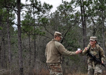 Best Squad cadre provide water to ruck march competitors during Best Squad challenge