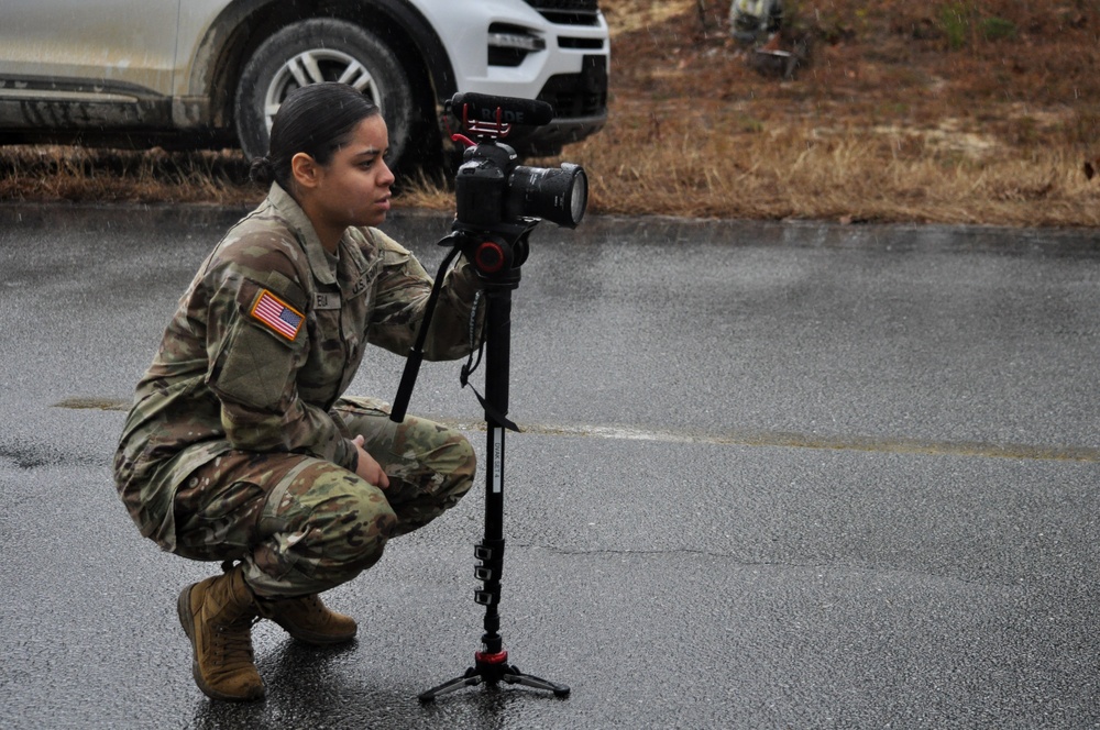 Public Affairs NCO challenges rain, cold to capture ruck march finishers in squad competition