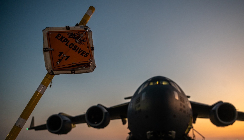 Airmen load cargo on C-17 Globemaster III