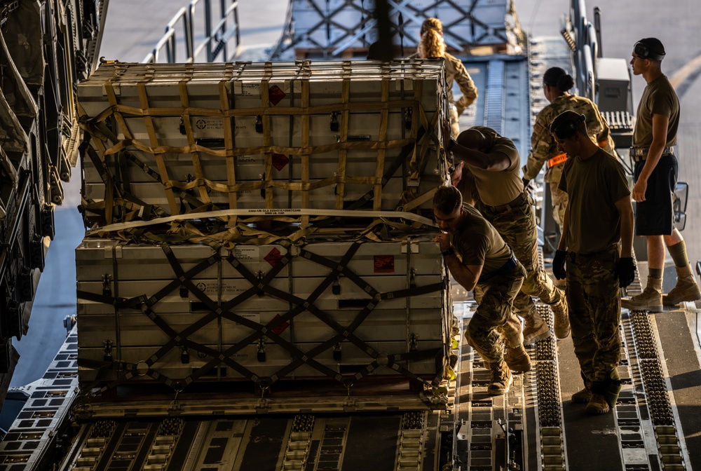 Airmen load cargo on C-17 Globemaster III