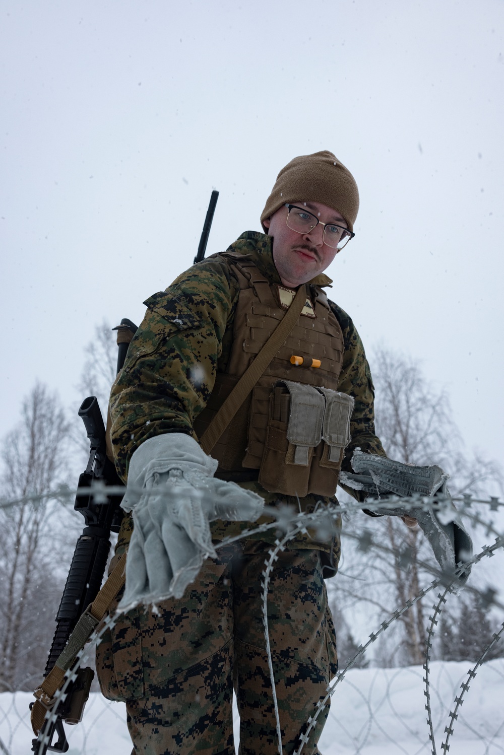 U.S. Marines with 2nd Marine Aircraft Wing set up concertina wire in preparation for Exercise Nordic Response 24