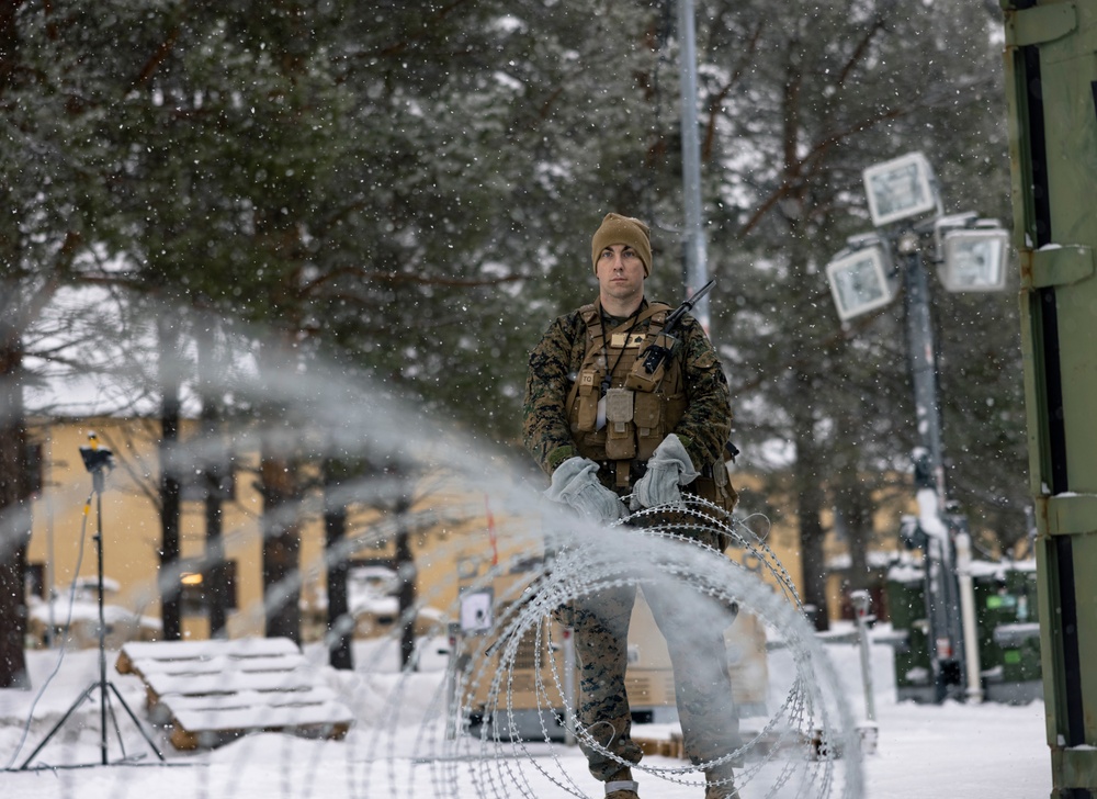 U.S. Marines with 2nd Marine Aircraft Wing set up concertina wire in preparation for Exercise Nordic Response 24