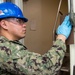 USS Ronald Reagan (CVN 76) Sailors conduct door maintenance