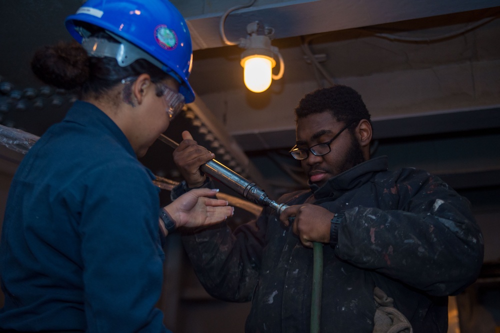 USS Ronald Reagan (CVN 76) Sailors prepare corrosion control tools