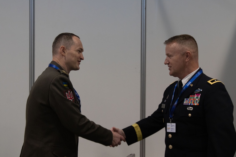 U.S. Army Maj. Gen. Michael Leeney, commanding general of Task Force Spartan, meets with Armed Forces of Ukraine Col. Roman Muzychenko at the World Defense Show