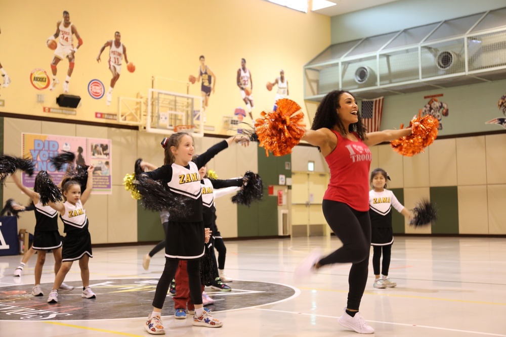 One of the visiting NFL cheerleaders, right, dances with children at a cheerleading clinic held at the Camp Zama Youth Center on Feb 10.