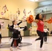 One of the visiting NFL cheerleaders, right, dances with children at a cheerleading clinic held at the Camp Zama Youth Center on Feb 10.