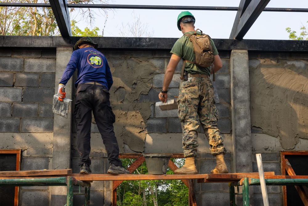 Cobra Gold 24; Marines with Marine Wing Support Squadron 171 apply stucco at the Ban Prakaet School